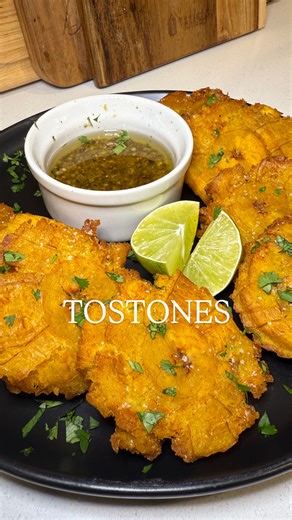 Authentic Cuban Tostones w/ Garlic Mojo 🇨🇺🔥 recipe ⬇️ 3 green plantains, peeled and cut into 1 inch chunks 2 cups water 1 tbsp garlic powder 1 tsp salt Oil Cut 3 or 4 slits down the sides of the plantains. Peel and cut into 1 inch chunks. Fry in oil until slightly golden, about 3-4 minutes. Cool down and use a tostonera, cup or bowl to evenly flatten (not too thin). Combine water, garlic powder and salt in a bowl. Dip flattened plantains into the garlic salt water for 10 seconds and fry again