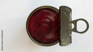 A closeup of a tin can lid with an easy open tab peeling back to reveal red ripe tomato's inside