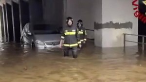 Driver rescued as car pulled from floods in Italy