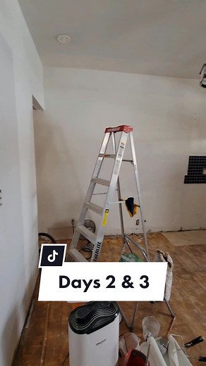 Days 2 & 3 of the kitchen reno involved a lot of patching, sanding, and painting. We also reinstalled the cabinets I refinished in phase one of the kitchen reno! In order to lay the flooring properly, we needed to make sure it was flat. You can see us running a 4 ft level horizontally & vertically around the room and marking any spots that dipped more then 1/8