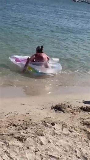 Woman Struggles to Balance on Top of Inflatable Bed