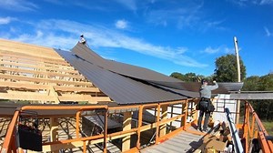 When installing long lengths of steel on the roof, we have found this to be the best method! An added bonus when the steel has drip stop applied to the bottom of it for condensation control. It slides so nicely over the roof and it takes less effort to avoid any scratches. This method however, is also why we never punch our roof steel! We mark every purlin on the way back down to grab the next sheet. You can really fly and lay a bunch of steel quick with this method and with very little physical