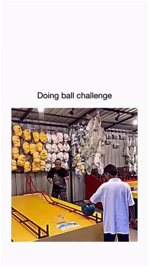 globalreel.lio on Instagram: "The video compiles multiple failed attempts at the “Bowler Roller” carnival game, where players roll a bowling ball up a ramp with a central hump to win prizes, but it consistently rolls back, ending with one success via gentle backspin to crest the hump. - High engagement (4M+ views, 4K likes) stems from the satisfying payoff and relatable frustration, with replies debating the game’s rigged design while sharing tips like minimal force and spin for victory, backed