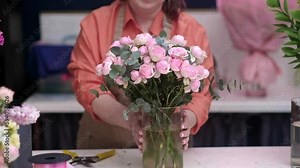 successful and creative female entrepreneur and owner of flower shop stands with poise and confidence, a bouquet of blooms in hand, small business