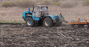 Tractor Plowing Field, Slow motion. Seasonal Tillage on a Farm. Agriculture.