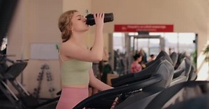 Woman walking on a treadmill in gym