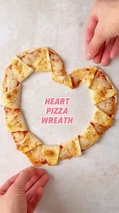 These heart pizza wreaths are perfect for a Valentine’s or Galentine’s night in. Just cut a tortilla into a heart shape as shown, then slice from the centre towards the outside (leaving the edge uncut). Fill the edge with tomato sauce and plenty of cheese, then fold the slices outwards. Brush with egg and bake until golden. #pizza #heartshapedpizza #heartshapedfood #pizzanight #galentines | The Fast Foodie