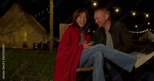 Romantic couple in love having fun time near their tent with lighting during romantic trip Stock Video