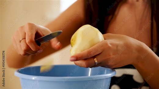Slicing a pear for a simple snack in a kitchen setting during daytime hours