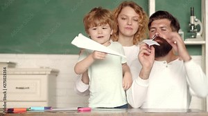 Happy child playing with toy paper airplane. Children Education and Pupils Education. First day at school. Back to school. School community partnership models.