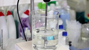 Laboratory Overhead Stirrer Mixes Solution in Lab Beaker. Transparent Liquid Being Stirred in an Experiment. Research and Development.