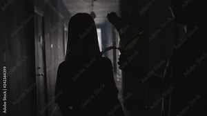 Silhouettes of man giving flowers to woman and embracing her while meeting together in hallway