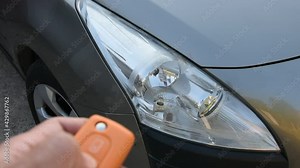 Locking and unlocking a car door with remote control central locking.