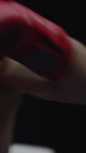 Muscular man boxing on black background. Young male boxer practicing shadow boxing