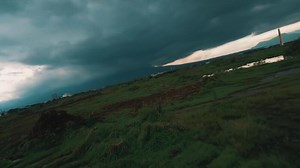 Dramatic Storm Clouds Over Green Field