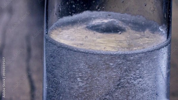 Tiny bubbles rise and burst, carrying whispers of liquid transformation