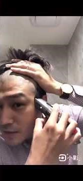 handsome guy shaves his head by himself