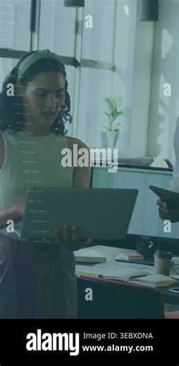 Vertical video: Woman typing laptop while coworker pointing phone, code overlay growing, debugging. Computer, collaboration, coding, office, daylight, monitor, vertical video Stock Video Footage - Alamy