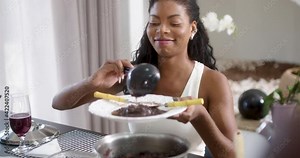 Beautiful latinx woman eating feijoada - typical brazilian food