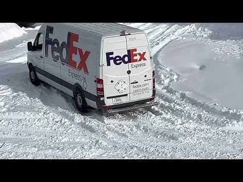 Fedex truck stuck on thick snow filled road
