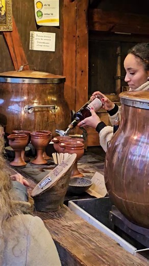 In the Christmas Market in Odeonplatz in Munich drinking Feuerzangenbowles. It's hot-spiced Glühwein with a burning 🔥 sugar cube dripping into releasing pure happiness. Also available were scrambled pancakes. Yes, you read correctly. Here is a stand igniting the fiery happy drinks. Not pictured, but nearby is Rich Carbonara. | Bamberg Beer Me! Beer Tours of Bamberg, Germany