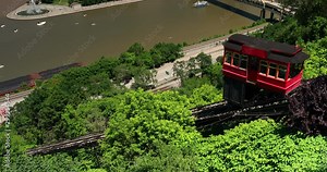 Cable car rides up the Duquesne incline on the south shore of Pittsburgh Pennsylvania USA looking over the Monongahela River and city skyline