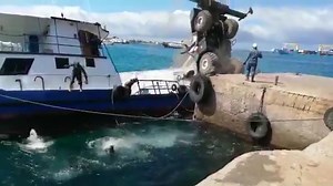 Horrifying moment crane collapses onto boat