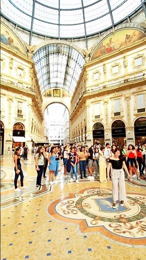 Galleria Vittorio Emanuele, spinning on the mosaic bull, Milan, Lombardy, Italy