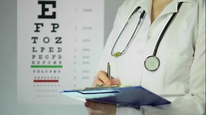 Hard-working optician prescribing medication to patient at clinic, healthcare