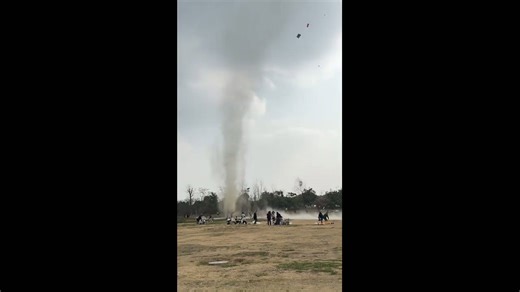 Swirling dust devil captivates visitors in public park in Sichuan, China