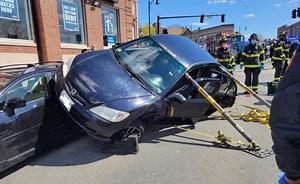 Driver extricated after Medford crash leaves car on top of another vehicle