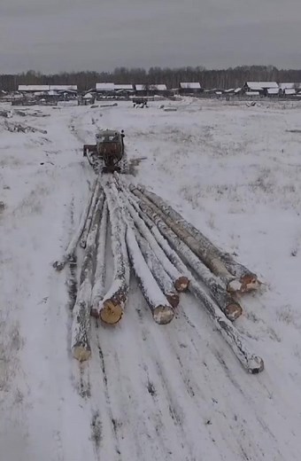 Old Tractor Clearing Snow in Winter Forest