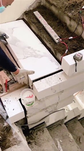 the process of installing ceramic tiles on stairs