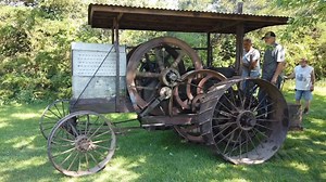Check out this antique tractor! This 1908 Friction Drive is the first model tractor the International Harvester Company built. It’s powered by a 20 horsepower horizontal International gasoline engine with one speed forward and one speed reverse. The engine slides on a set of rollers and pushes into a large friction wheel that moves the tractor forward. An arm swings upward with another friction wheel to move the tractor in reverse. These were only built for a few years and were quickly replaced 