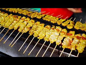 Thai style pork Satay with peanut curry sauce, Street food Bangkok.