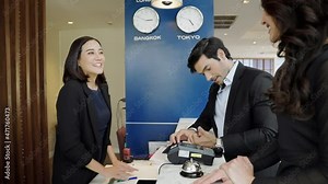 The guest is using a credit card with the edc machine to pay for services in the hotel lobby.