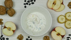 Granola with yogurt breakfast. Preparation and eating. Stop motion animation. Top view