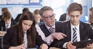 4k, Mature teacher spending some one-on-one time with her students during class.