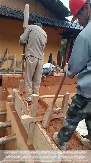 With each hammer blow and tamping, the soil is rammed into a wall.