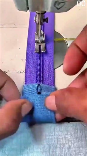 Attaching bright blue zipper to matching fabric using industrial sewing machine with preci