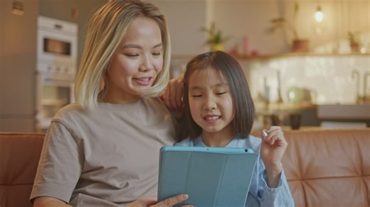 Mother helping her daughter with online homework - Free Stock Video