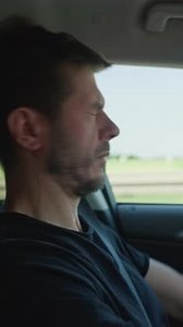 Tired Man Driving Car on Road Trip