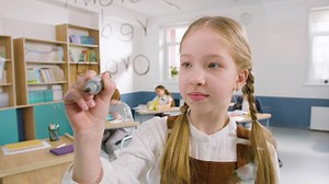 Free stock video - Pretty little girl in classroom writing colors in english on a glass board at school 1