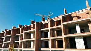 Construction work at the construction site. The house is made of bricks and gas blocks with a floor. A house without windows
