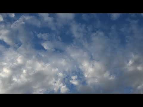 Enjoy a bright and calming 4K timelapse of white summer clouds fill the screen moving slowly