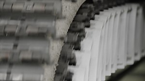 Premium stock video - Newspapers move along a conveyor belt at a newspaper factory 6
