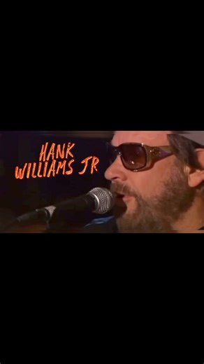 Hank “Bocephus” Williams Jr. Pays tribute to Merle Haggard’s classic song “Are the Good Times Really Over” at the Great American Country (GAC) Cracker Barrel Country Songs of the Year Concert in 2006. #HankWilliamsJr #Bocephus #MerleHaggard #AreTheGoodTimesReallyOver #ClassicCountry #CountryMusic #GAC #CrackerBarrel #CountrySongsOfTheYear #LivePerformance #CountryLegends #Nostalgia #2006Concert #HonoringLegends #TraditionalCountry | Twang Country