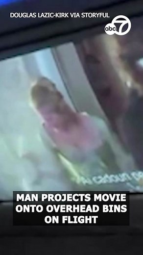 An airline passenger brought a projector onto a plane and used it to watch a feature film on an overhead bin during a flight. Video shows the 2000 Mel Gibson movie