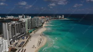 Aerial view on beautiful Cancun beach in Mexico with luxury hotels and holiday resorts. Travel, tourism and vacation concept shot by drone in 4K. Playa Cancun, Riviera Maya, Quintana Roo, Mexico.