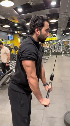 Cable tricep pushdowns are an exercise that targets the triceps using a cable machine. To perform the exercise, stand facing the machine with your feet shoulder-width apart and grip the straight bar attachment with an overhand grip. Keeping your elbows stationary, push the bar down towards your thighs, extending your arms completely. Hold briefly and return to the starting position. Focus on engaging your triceps muscles and avoiding momentum to maximize effectiveness. Repeat for several repetit